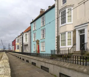 Historic houses overlooking harbour on medieval Town Wall