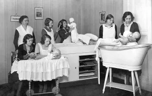 Historic photo, women learning how to deal with newborn babies