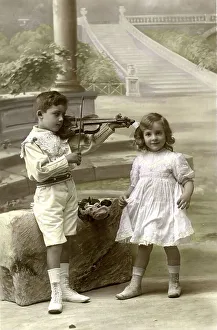 Historic photograph, boy playing violin for his friend