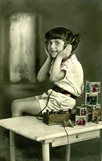 Historic photograph, child listening to the radio