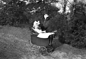 Historic photograph, girl playing with a doll