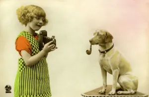 Historic photograph, girl taking a picture of a dog smoking a pipe