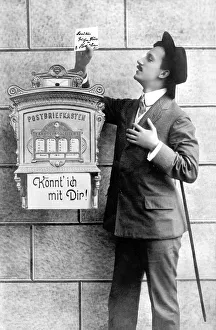Historic photograph, man next to a letterbox
