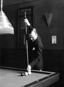 Historic photograph, man playing billiards
