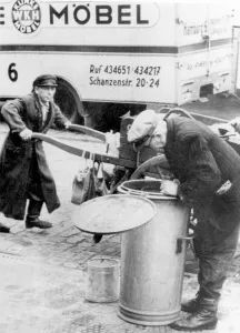 Historic photograph, man sifting through a garbage can