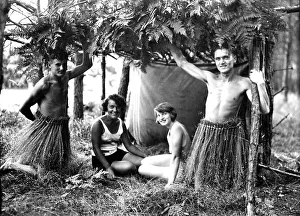 Historic photograph, two men wearing bast skirts with their girlfriends
