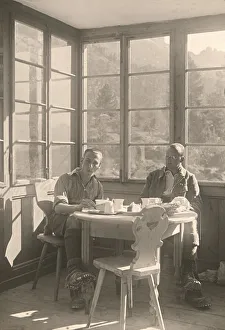 Historic photograph of a mountain climber taking a break at an alpine restaurant