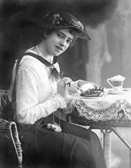 Historic photograph, woman eating cake