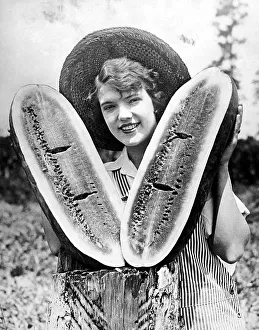 Historic photograph, woman holding a large melon