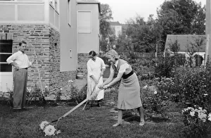 Historic photograph, woman mowing the lawn