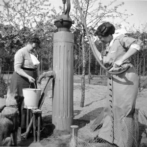 Historic photograph, two women getting water