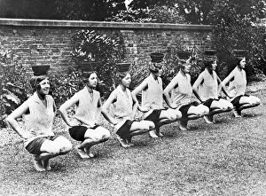 Historic photograph, young women balancing bowls on their heads