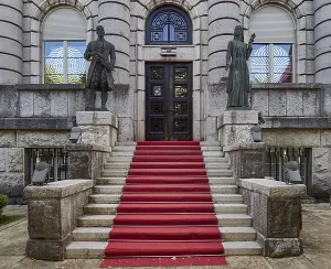 Historic staircase with red carpet and sculptures in front of a building Ministry of Culture Cetinje Montenegro