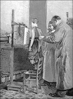 Historical illustration, 1899, a boy is being prepared for an x-ray of his breast