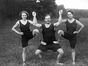 Historical image, man with two women wearing sporting outfits