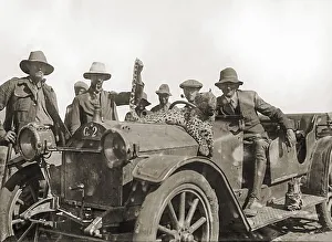 Historical picture, farmers with killed leopard on a car