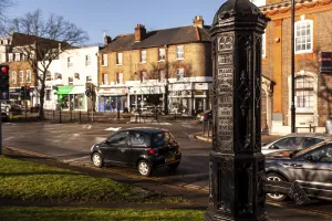 Historical street post with cars and shops