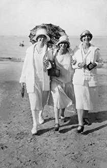 Holiday, three women with beach umbrellas