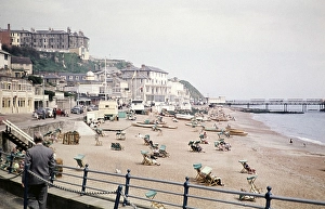 Holidaymakers sunbathing in deckchairs on a sandy beach, Esplanade, Ventnor, Isle of Wight, Hampshire, England, UK 1960