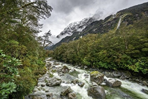 Hollyford river with snowy mountains