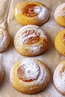 Homemade cookies with orange jam lies on cooking paper