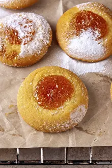 Homemade cookies with orange jam lies on cooking paper