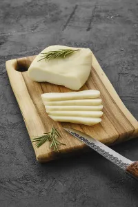 Homemade country style goat cheese on cutting board