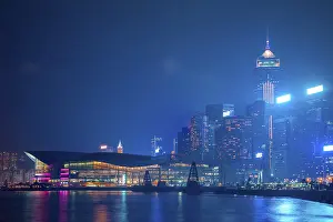 Hong Kong. Night quay, light mist and city lights