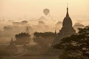 Category Buddhism Prints: Hot air balloon over the landscape in the early morning fog