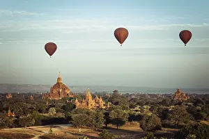 Hot air balloons flying at sunrise over ancient Buddhist Temples at Bagan