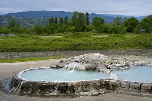 Framed Print : Hot spring pool surrounded by green landscape and forested mountains in the background Framed Print : Hot spring pool surrounded by green landscape and forested mountains in the background