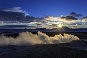 Hot springs and geothermal area in front of mountain landscape in winter