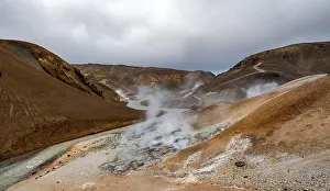 Hot springs and steaming stream between colourful rhyolite mountains