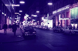 Hotel Ambassador and shops on Kartnerstrasse, Vienna, Austria at night early 1960s