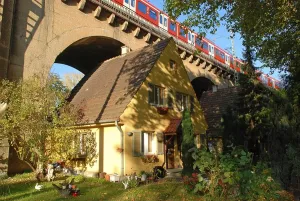 House built under train bridge Stuttgart Nordbahnhof Baden Wuerttemberg Germany