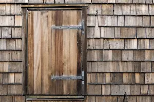 House facade with wooden shingles and windows