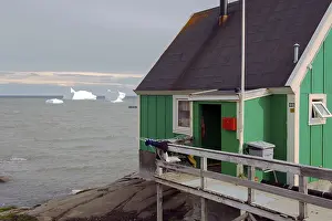 House and iceberg in bay, Qeqertarsuaq, Greenland