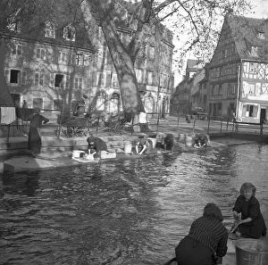 Housewives do their laundry on the banks of a river
