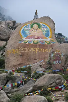Huge Buddha painted on a rock behind the Drepung temple