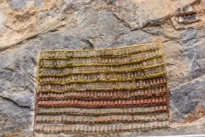 Hundreds of tiny Buddha Statues on limestone rock