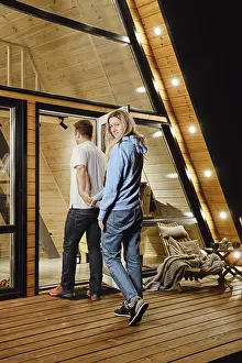 A husband and wife enter tiny house after an evening walk