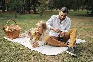 Husband wife having picnic together outdoors