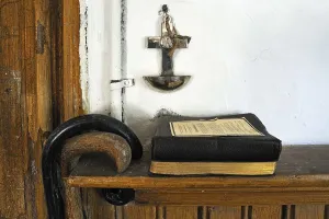 Hymnal, cross with holy water font and walking stick in a parlour at the time around 1940