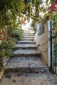 I walk between houses in Mojacar with white houses on top of the mountain