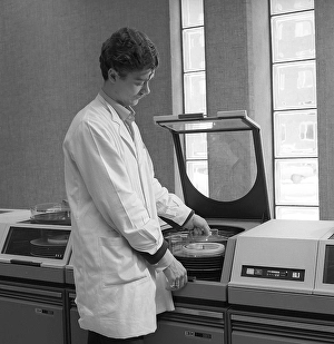 IBM mainframe system 360. A man in a room where some of the computer equipment is visible. The IBM 2311 Direct Access Storage Facility was introduced in 1964 for use in the entire System/360 family of computers