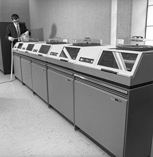 IBM mainframe system 360. A man in a room where some of the computer equipment is visible. The IBM 2311 Direct Access Storage Facility was introduced in 1964 for use in the entire System/360 family of computers
