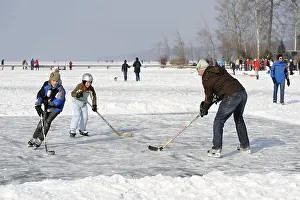Ice skaters and hikers at the little house on the lake