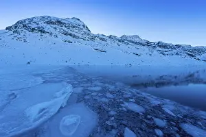 Ice structures in the black ice of the frozen Lago Bianco in the Swiss mountains