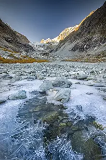 Framed Print : Ice structures on mountain stream with autumnal larches and mountain panorama