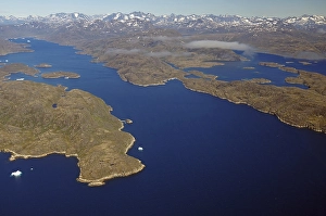 Iceberg, ice and islands, in a fjord